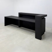 108-inch New York L ADA Reception Desk with Black Cinder Matte laminate desk, Black Cinder matte laminate workspace, Black Cinder matte laminate front panel, and Warm White LED with remote control.