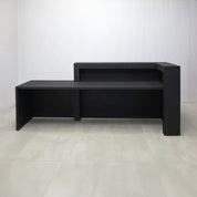 108-inch New York L ADA Reception Desk with Black Cinder Matte laminate desk, Black Cinder matte laminate workspace, Black Cinder matte laminate front panel, and Warm White LED with remote control.