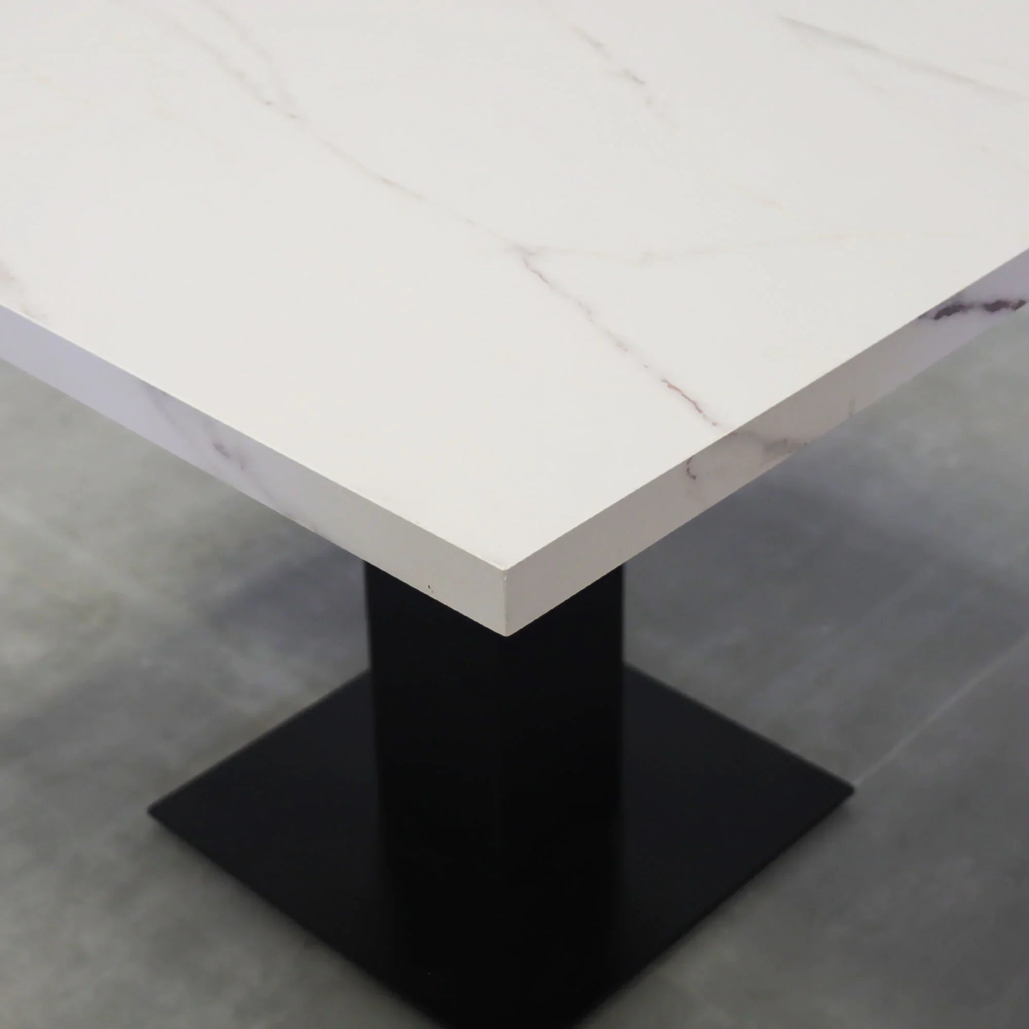 40-inch California X2 Round Conference Table in 1 1/2-inch solenne marble engineered surface top, black traceless laminate pedestal, metal powder coated base in black.
