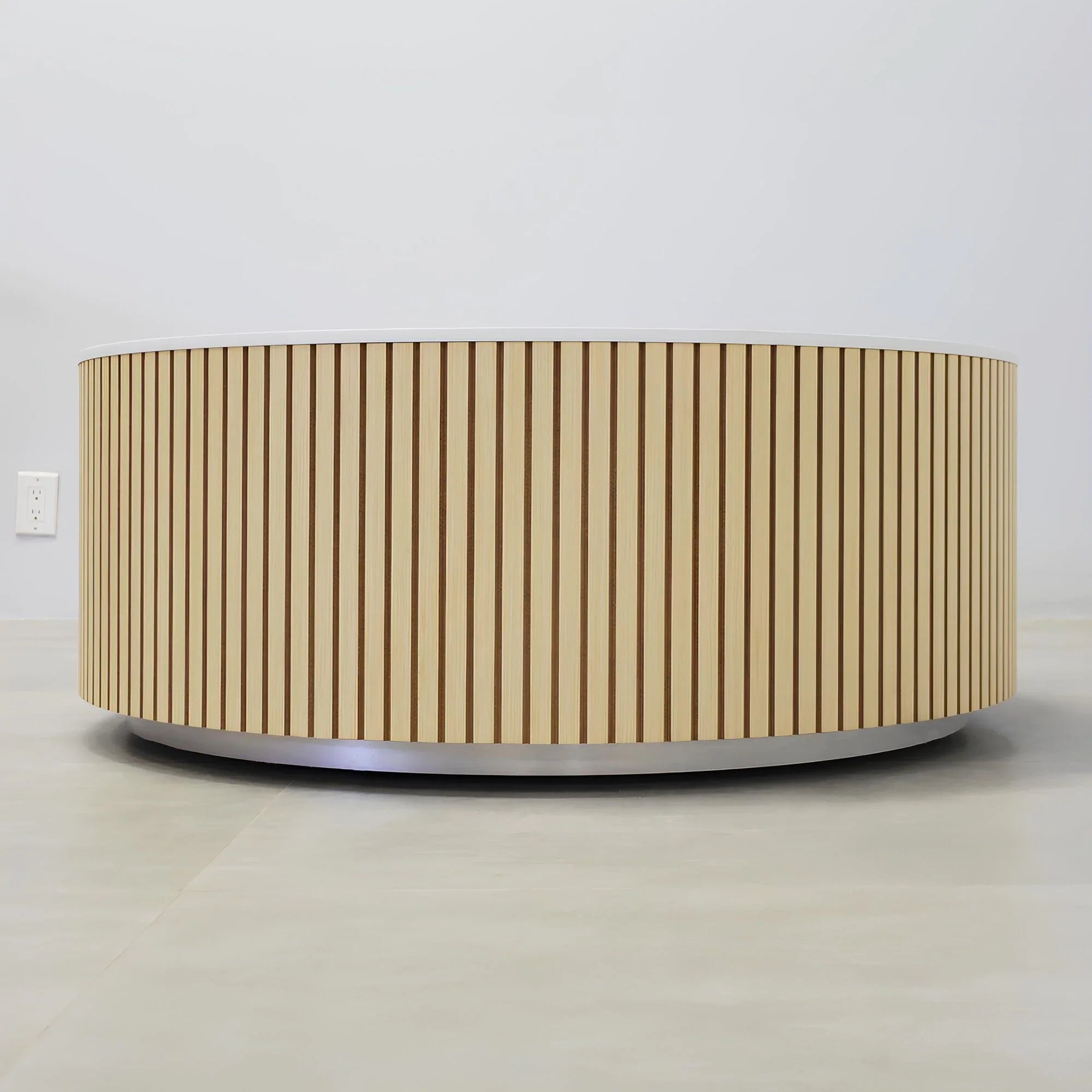 42-inch Norfolk Round Lobby Table with solenne marble engineered surface top, maple tambour table, and brushed aluminum toe-kick.
