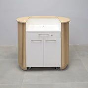 42-inch The Pill Podium & Host Custom Desk in white oak veneer top & toe-kick, white oak tambour main desk, and dover off-white matte laminate workspace. Built-in pencil drawer with lock, two doors with adjustable shelf and set of wheels.