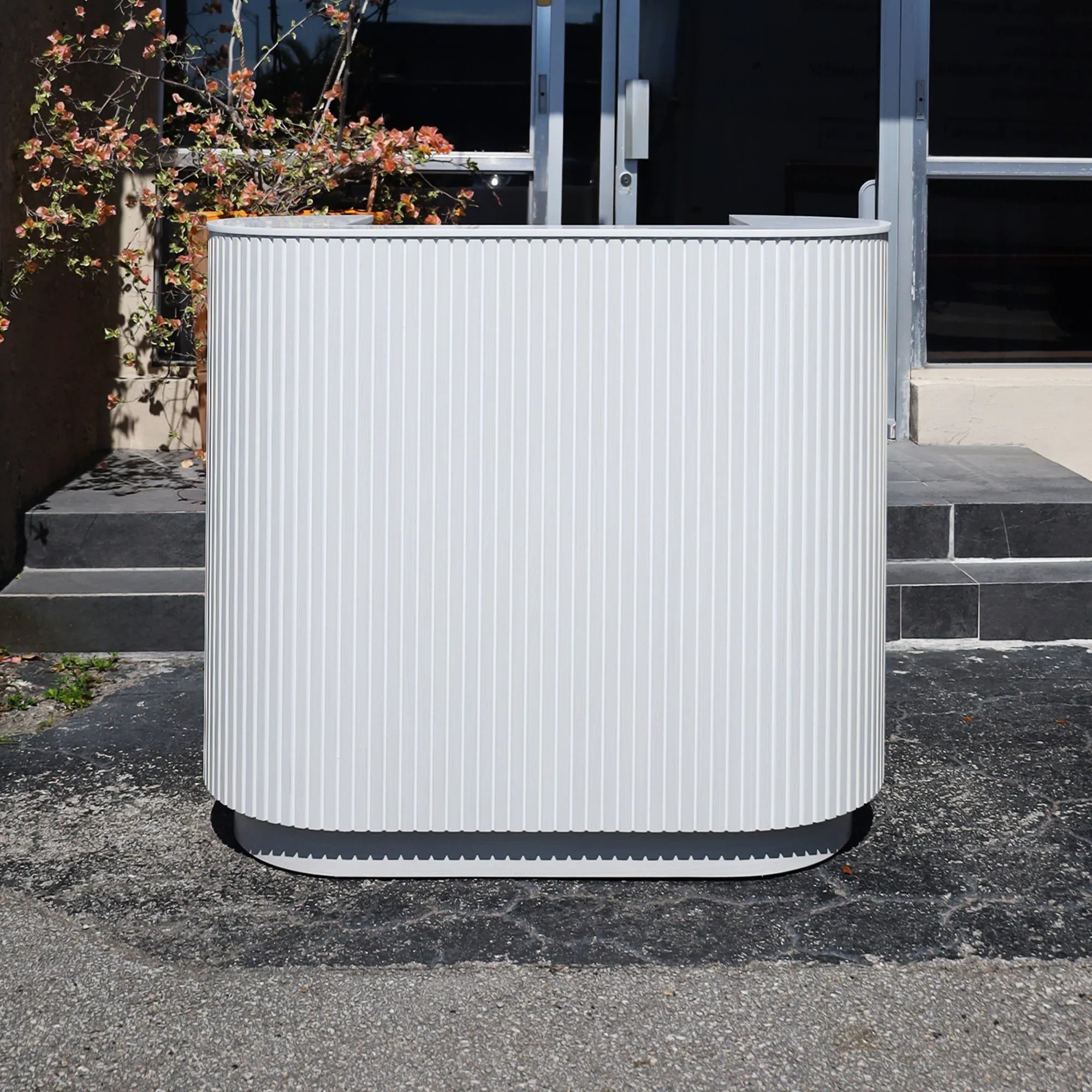 48-inch The Pill X2 Podium & Host Custom Desk White Ash Tambour front, White Solid engineered surface top, White Ash matte laminate workspace and toe-kick.