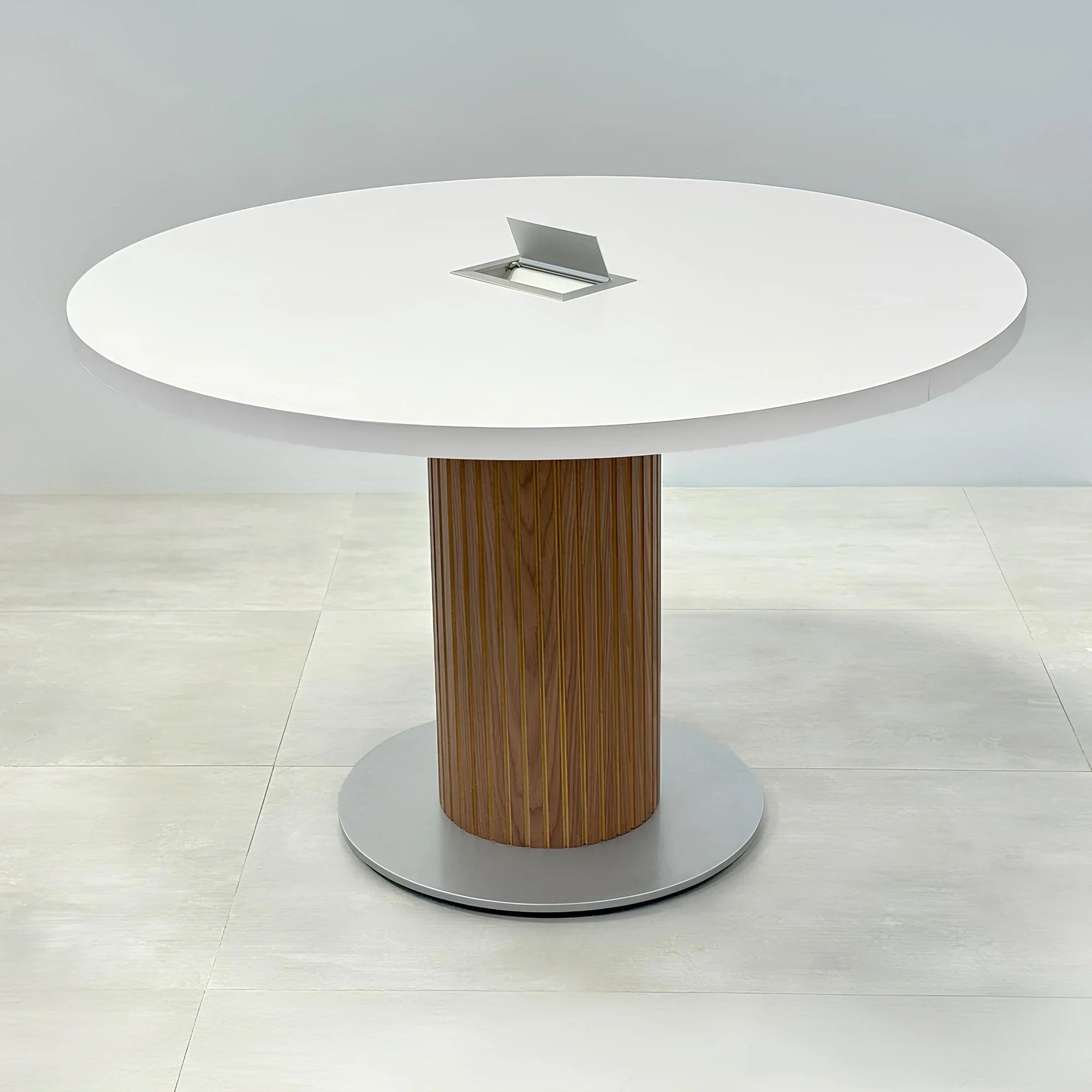 48-inch Newton Round Conference Table with X3 Base with white matte laminate top, walnut tambour with natural background, and silver powder-coated base.