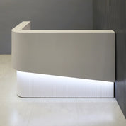 60-inch Nola L-Shape Curved Custom Reception Desk in folkstone gray matte laminate counter, white matte tambour front desk and white matte laminate workspace, with white LED, shown here.