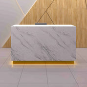 72-inch Houston Custom Reception Desk in calcutta stone pvc main desk and brushed gold toe-kick, with color LED, shown here.