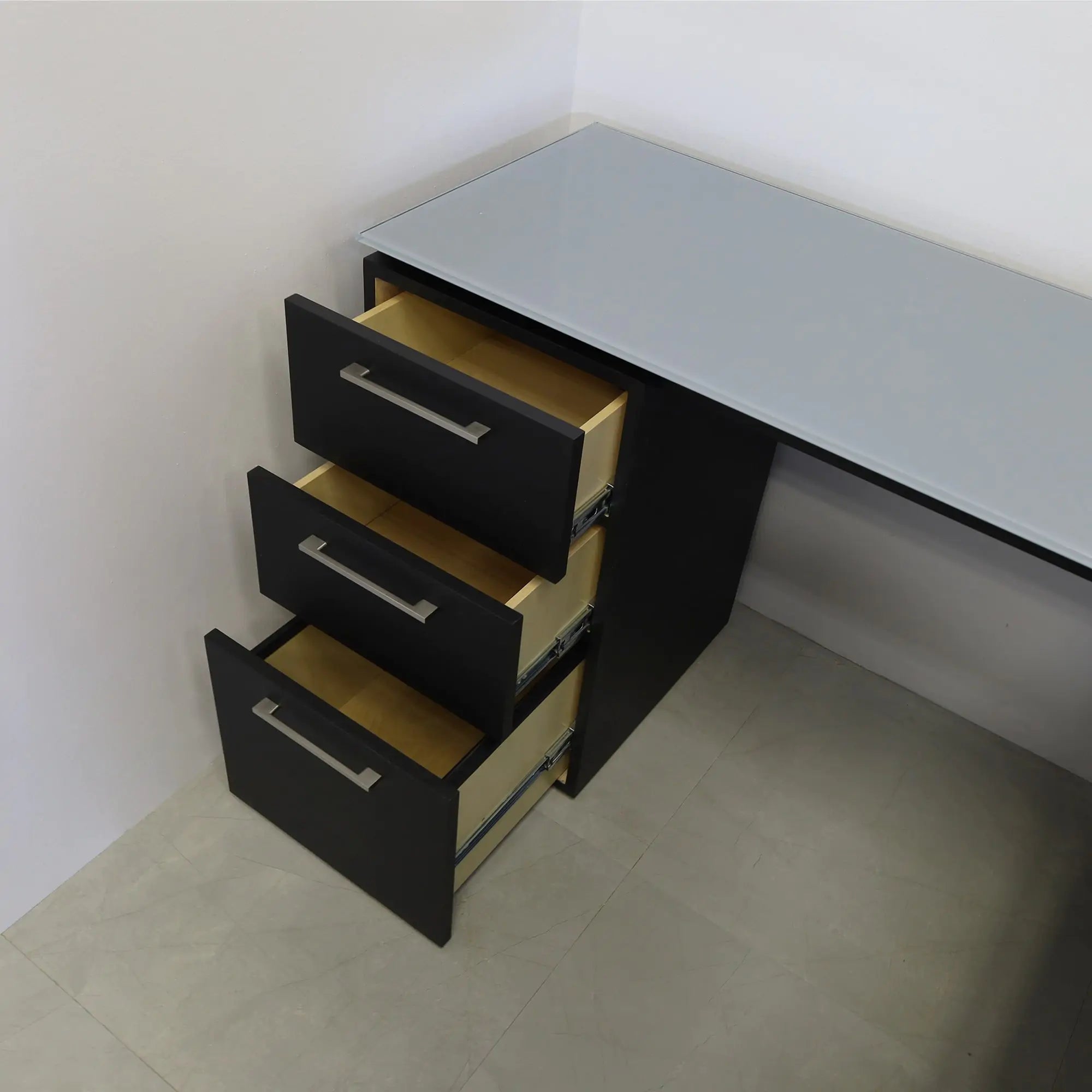 72-inch Denver L-Shape Executive Desk with return & cabinet on the left side when sitting, in 1/2" medium gray tempered glass top, black traceless laminate base, cabinet & privacy panel, shown here.