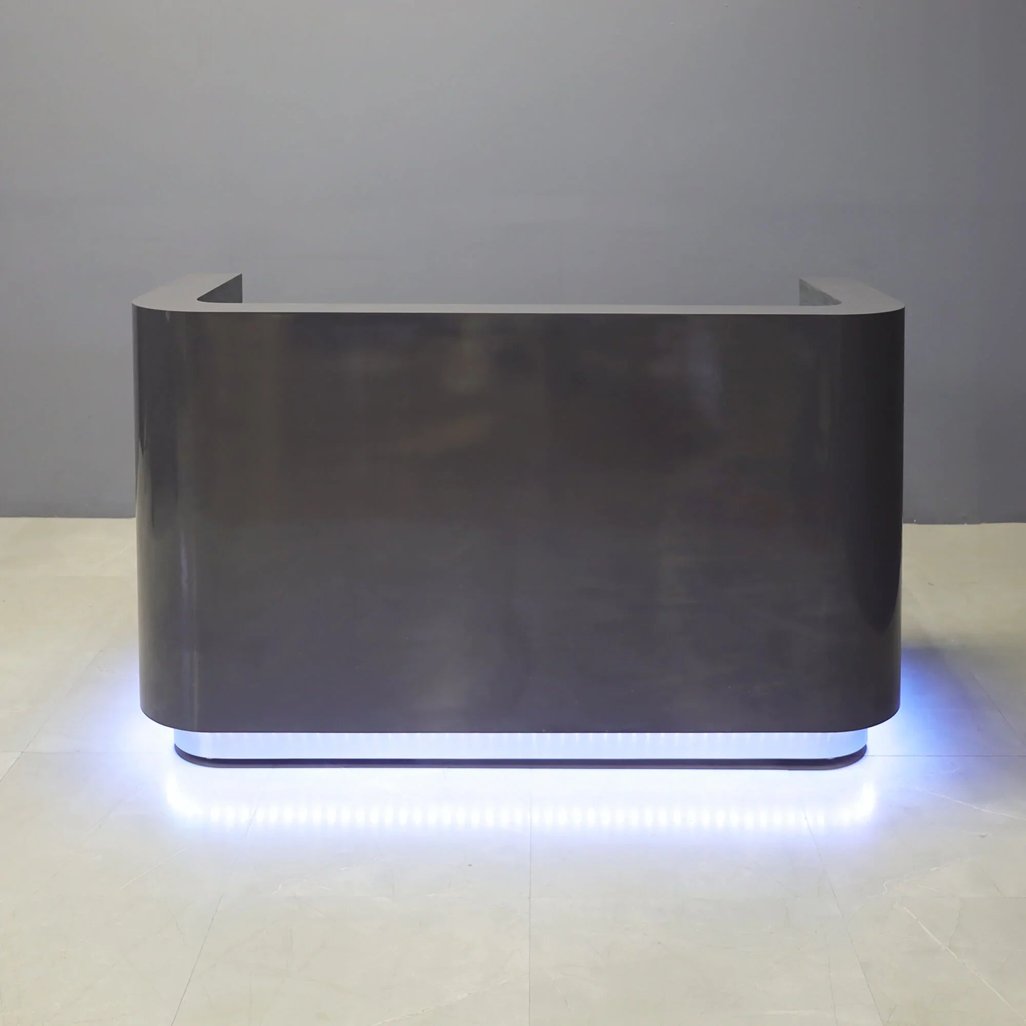 72-inch Nola Custom Reception Desk in storm gray gloss laminate main desk, brushed aluminum toe-kick, and warm white LED.