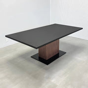 84-inch Newton Rectangular Conference Table with X3 Base with black traceless laminate top, metal powder-coated black base, and walnut tambour with black background pedestal.