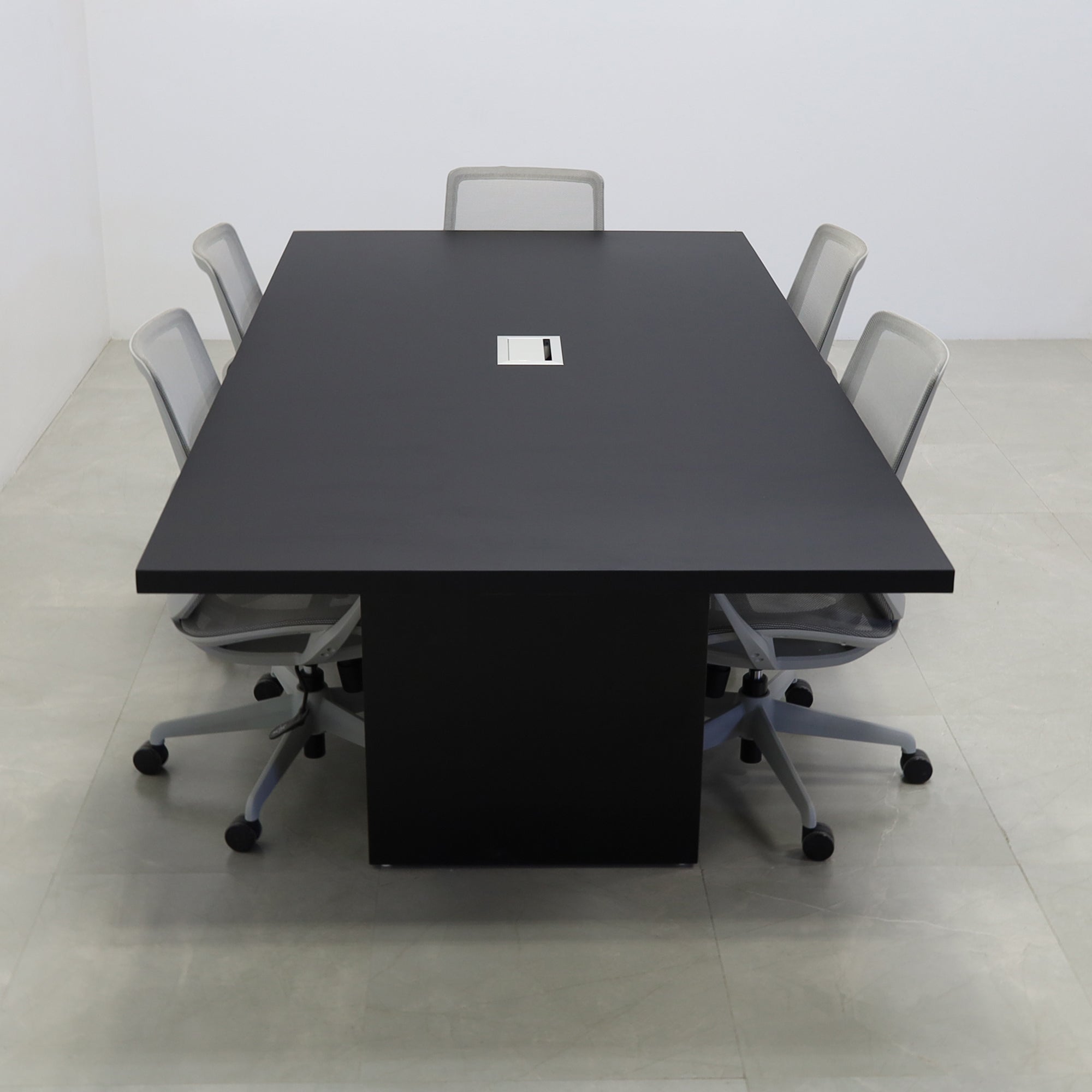 92 inches Newton Rectangular Conference Table in Black Traceless Laminate top and Black Matte Laminate base finish. Ellora power box, and six gray chairs shown here.