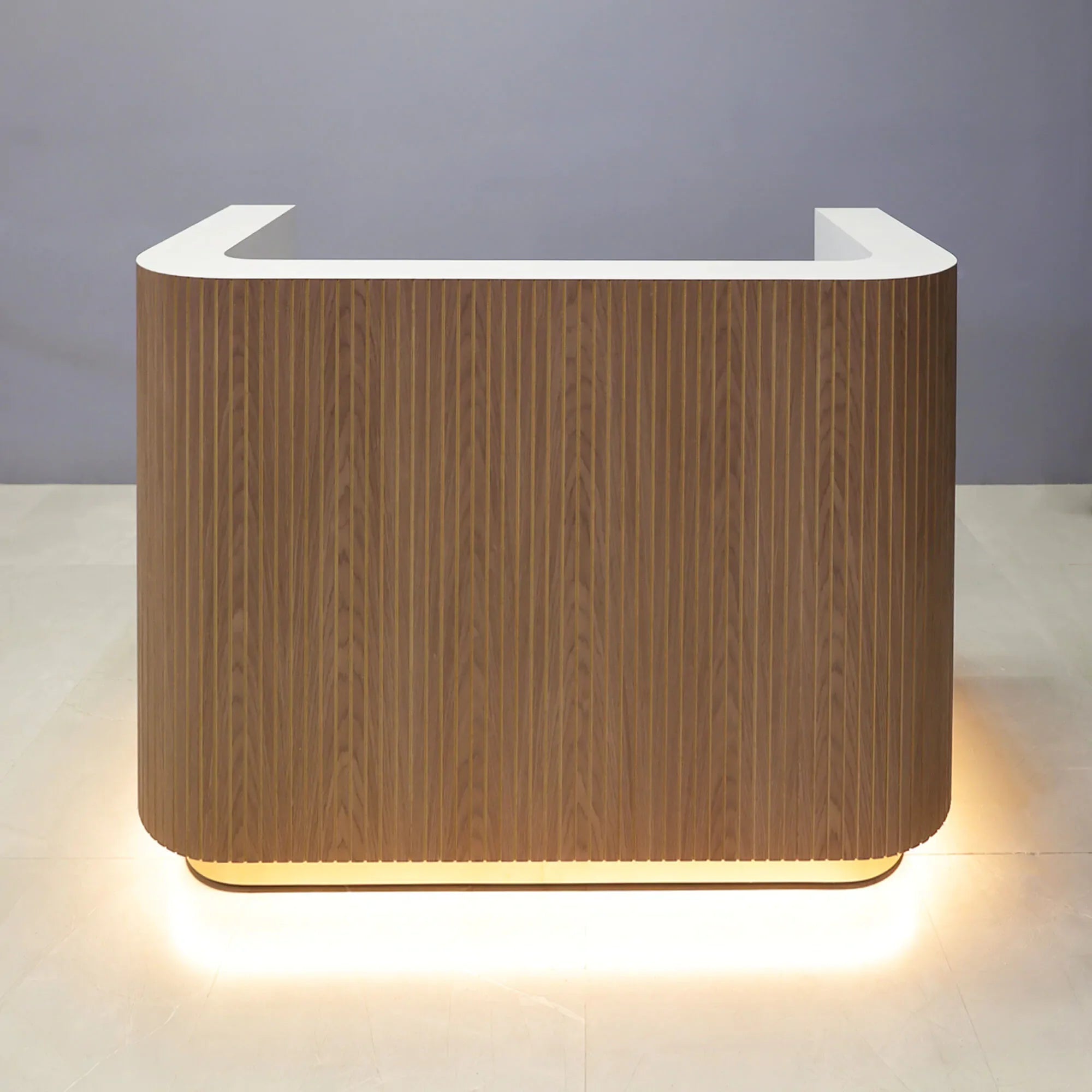 90-inch Nola Custom Reception Desk with white oak tambour main desk. white matte laminate workspace, and white LED.